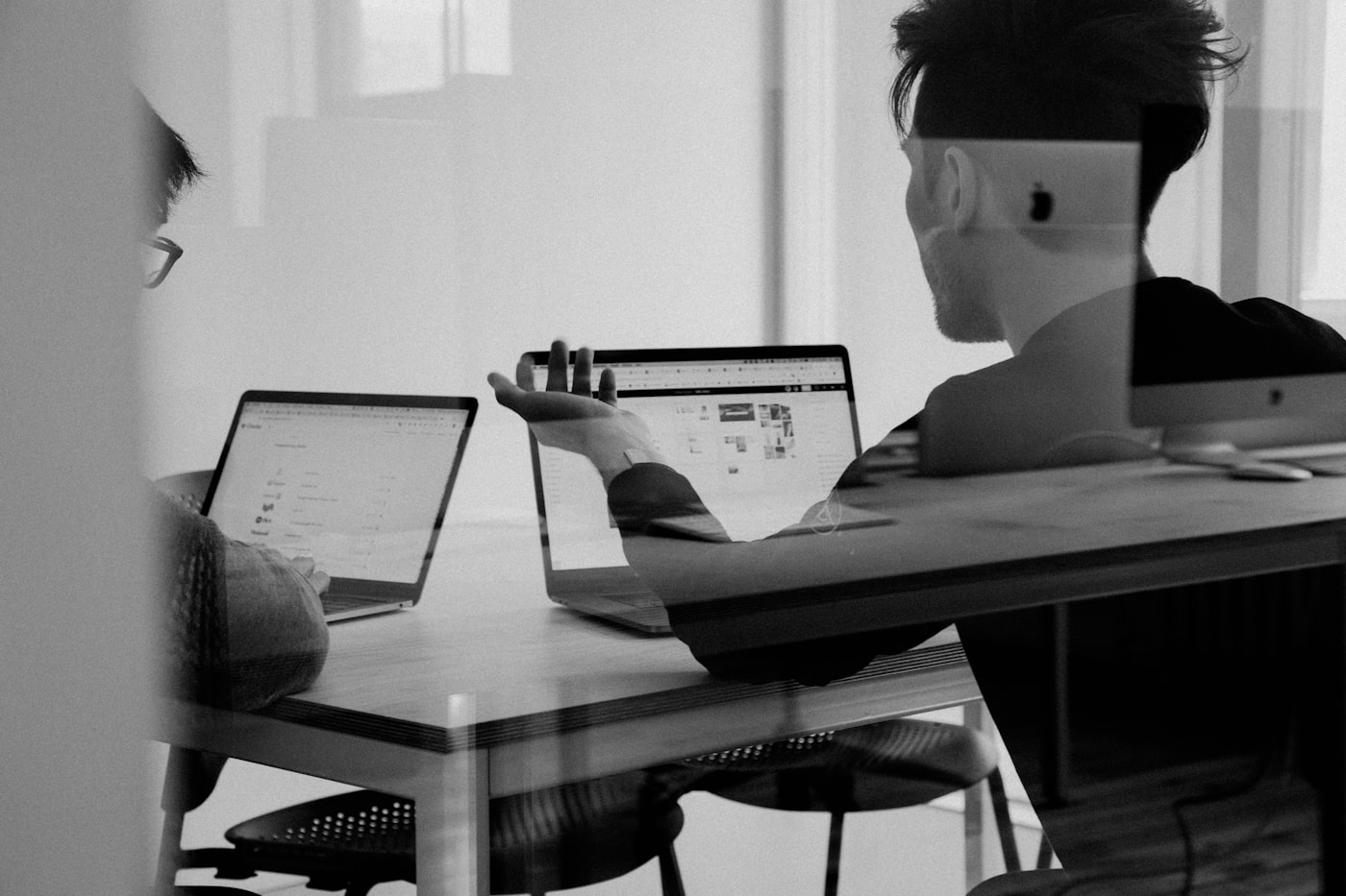 Office team coordinating operations on screens