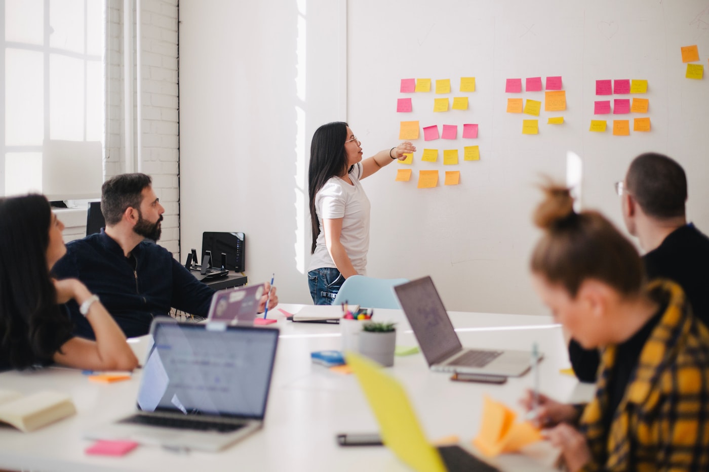 Consultants mapping business processes on a whiteboard